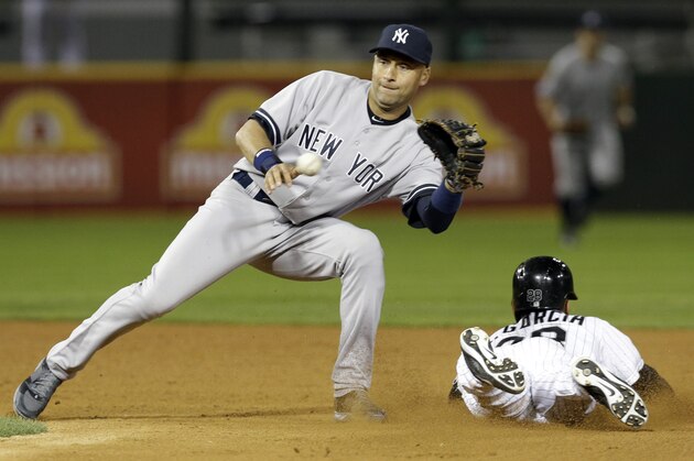 Chicago White Sox's Leury Garcia, right, steals second base as New York Yankees shortstop Derek Jeter tries to catch the ball during the eighth inning of a baseball game in Chicago on Friday, May 23, 2014. (AP Photo/Nam Y. Huh)