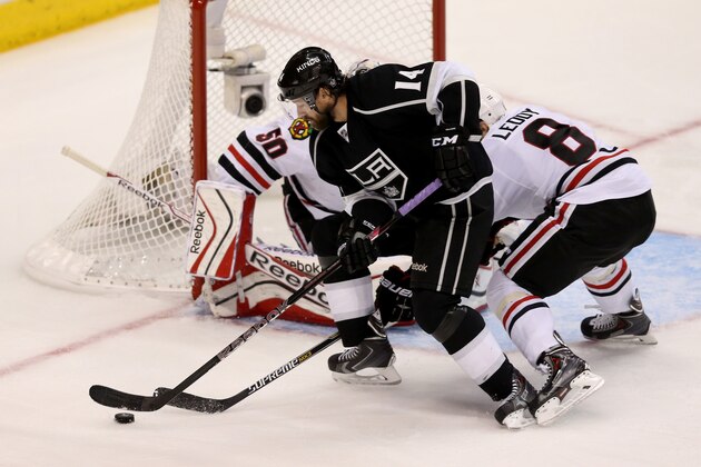 LOS ANGELES, CA - MAY 24:  Justin Williams #14 of the Los Angeles Kings with the puck in front of the net against Nick Leddy #8 and Corey Crawford #50 of the Chicago Blackhawks in Game Three of the Western Conference Final during the 2014 Stanley Cup Playoffs at Staples Center on May 24, 2014 in Los Angeles, California.  (Photo by Jeff Gross/Getty Images)