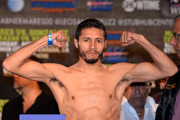LOS ANGELES, CA - AUGUST 23:  Jhonny Gonzalez poses as he steps on the scale at 125 pounds before his fight against Abner Mares during the weigh in at the Millennium Biltmore Hotel on August 23, 2013 in Los Angeles, California.  (Photo by Harry How/Getty Images)