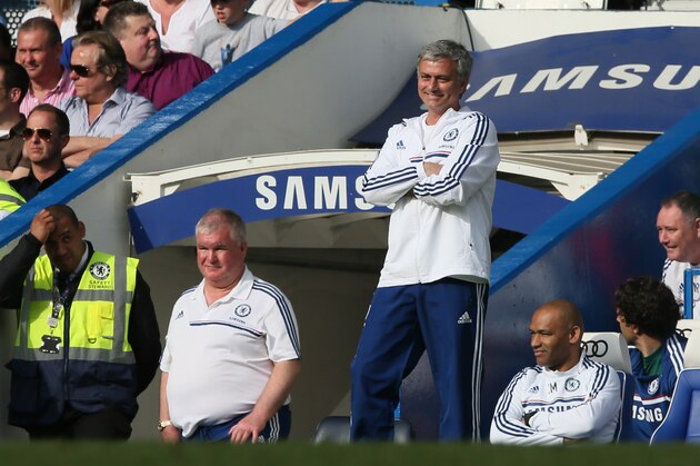 Chelsea manager Jose Mourinho smiles as he watches their English Premier League soccer match against Norwich City at Stamford Bridge stadium in London, Sunday May 4, 2014. (AP Photo/Alastair Grant)