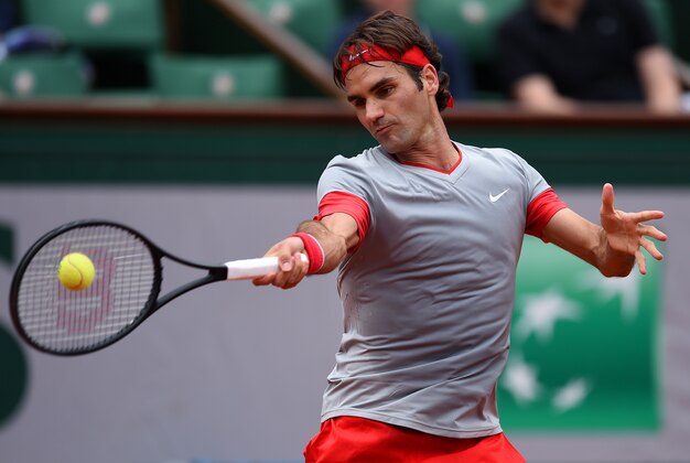 PARIS, FRANCE - MAY 25:  Roger Federer of Switzerland returns a shot during his men's singles match against Lukas Lacko of Slovakia on day one of the French Open at Roland Garros on May 25, 2014 in Paris, France.  (Photo by Matthias Hangst/Getty Images)