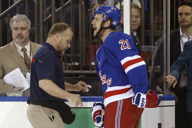 In this May 22, 2014 photo, New York Rangers center Derek Stepan (21) leaves the ice with a member of the Rangers staff after taking a hit from Montreal Canadiens forward Brandon Prust during the first period of Game 3 of the NHL hockey Stanley Cup playoffs Eastern Conference finals in New York. Stepan has a broken jaw and is undergoing surgery. Rangers coach Alain Vigneault made the surprising announcement Friday, May 23, 2014,  on the first of two off days in the series New York leads 2-1. Prust wasn't penalized in the first period of Montreal's 3-2 overtime win Thursday night, but he faces an NHL hearing Friday and a possible suspension. (AP Photo/Kathy Willens)