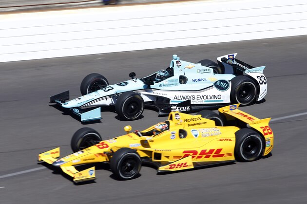 Ryan Hunter-Reay, bottom and James Davison, of Australia, head into the first turn on the final day of practice for the Indianapolis 500 IndyCar auto race at the Indianapolis Motor Speedway in Indianapolis, Friday, May 23, 2014. The 98th running of the Indianapolis 500 is Sunday. (AP Photo/Tom Strattman)