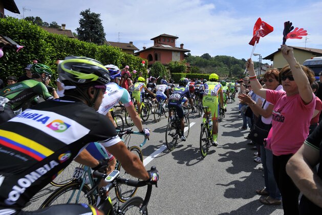 People cheer at cyclists at the start of the 15th stage of the Giro D'Italia cycling race from Valdengo to Plan di Montecampione, Italy, Sunday, May 25, 2014. (AP Photo/Gian Mattia D'Alberto)