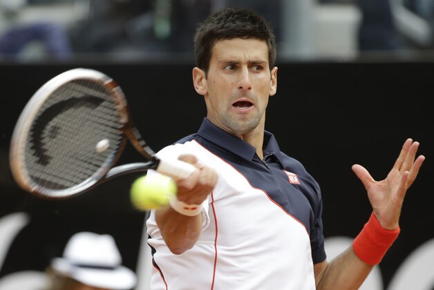 Serbia's Novak Djokovic returns the ball to Spain's Rafael Nadal during their final match at the Italian Open tennis tournament, in Rome, Sunday, May 18, 2014. Novak Djokovic extended his recent dominance over Rafael Nadal by rallying for a 4-6, 6-3, 6-3 victory Sunday to win the Italian Open for the third time. (AP Photo/Andrew Medichini)