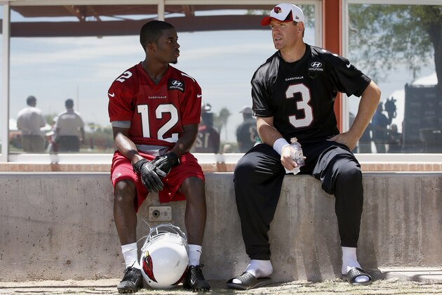 Arizona Cardinals quarterback Carson Palmer (3) talks with rookie wide receiver John Brown (12) after an NFL football organized team activity workout at the Cardinals training facility on Tuesday, May 20, 2014, in Tempe, Ariz. (AP Photo/Ross D. Franklin)