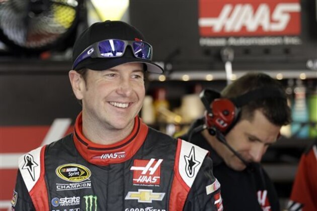 Kurt Busch smiles following practice for Sunday's NASCAR Sprint Cup series Coca-Cola 600 auto race at the Charlotte Motor Speedway in Concord, N.C., Saturday, May 24, 2014. (AP Photo/Gerry Broome)