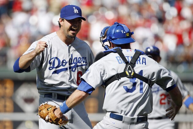 Los Angeles Dodgers starting pitcher Josh Beckett, left, celebrates with catcher Drew Butera after striking out Philadelphia Phillies' Chase Utley looking for a no-hitter baseball game, Sunday, May 25, 2014, in Philadelphia. Los Angeles won 6-0. (AP Photo/Matt Slocum)