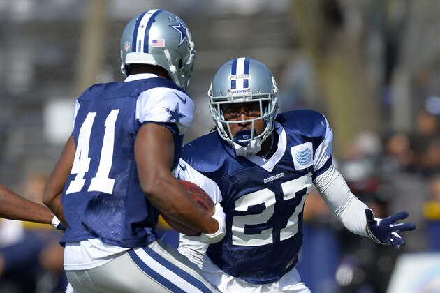 Dallas Cowboys defensive back J.J. Wilcox, right, tries to stop strong safety Eric Frampton during NFL football training camp on Friday, July 26, 2013, in Oxnard, Calif. Wilcox did not hesitate when the Cowboys rookie was asked if he knew who Bill Bates was.