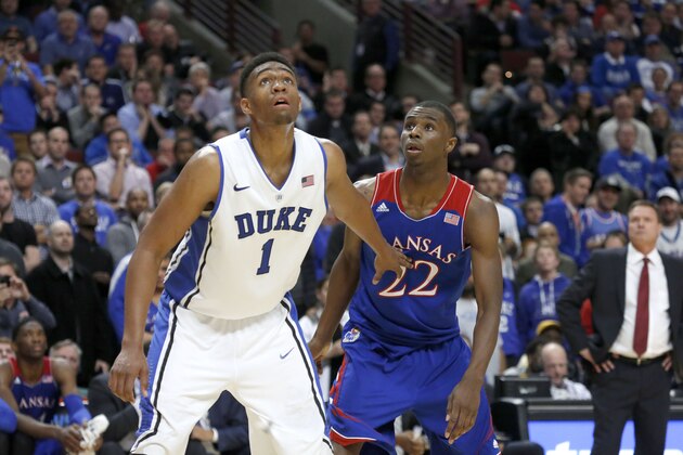 Duke forward Jabari Parker and Kansas guard Andrew Wiggins look for a possible rebound off a free-throw attempt during the second half of an NCAA college basketball game Tuesday, Nov. 12, 2013, in Chicago. Kansas won 94-83. (AP Photo/Charles Rex Arbogast)