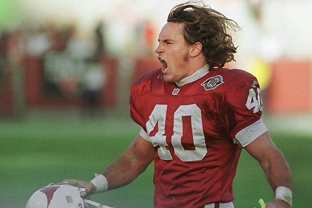 ADVANCE FOR WEEKEND EDITIONS, MAY 3-4 - FILE - In this Dec. 20, 1998, file photo, Arizona Cardinals safety Pat Tillman celebrates after tackling New Orleans Saints running back Lamar Smith for a loss in the third quarter of an NFL football game in Tempe, Ariz. Pat's Run is filled with inspirational stories all wanting to honor the memory of NFL star-turned-soldier . For seven years, Sheldon Davidson had become the annual exclamation point to the run, climbing out of his wheelchair and dragging the paralyzed left side of his body across the final 42 yards. He died 42 days before this year's run, so his wife and daughter made the journey without him, honoring two heroes with every step.  (AP Photo/Roy Dabner, File)