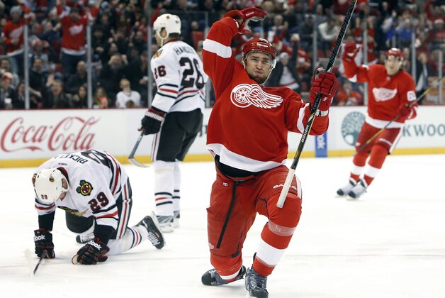 Detroit Red Wings defenseman Kyle Quincey, right, celebrates his goal against Chicago Blackhawks goalie Corey Crawford in the second period of an NHL hockey game Wednesday, Jan. 22, 2014, in Detroit. (AP Photo/Paul Sancya)