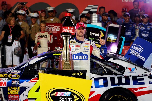 CHARLOTTE, NC - MAY 25:  Jimmie Johnson, driver of the #48 Lowe's Patriotic Chevrolet, poses in victory lane after winning the NASCAR Sprint Cup Series Coca-Cola 600 at Charlotte Motor Speedway on May 25, 2014 in Charlotte, North Carolina.  (Photo by Jerry Markland/Getty Images)
