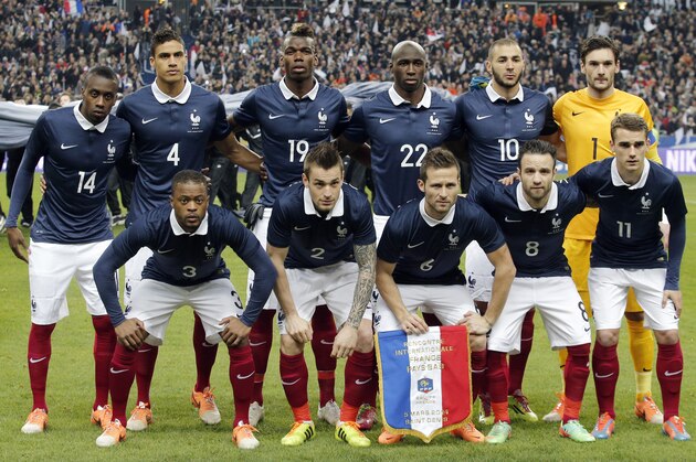 French soccer team players pose before the international friendly match between France and Netherlands at the Stade de France stadium, outside Paris, Wednesday, March 5, 2014. From left background: Blaise Matuidi , Raphael Varane, Paul Pogba, Eliaquim Mangala, Karim Benzema, and Hugo Lloris. From left foreground : Patrice Evra, Mathieu Debuchy, Yohan Cabaye, Mathieu Valbuena and Antoine Griezmann. (AP Photo/Christophe Ena)