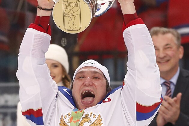 Russia forward Alexander Ovechkin celebrates as he holds up the trophy after Russia defeated Finland 5-2 in the gold medal match at the Ice Hockey World Championship in Minsk, Belarus, Sunday, May 25, 2014. (AP Photo/Darko Bandic)