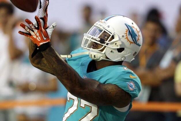 Miami Dolphins cornerback Jamar Taylor (22)catches a pass before the start of an NFL preseason football game against the Tampa Bay Buccaneers, Saturday, Aug.24, 2013 in Miami Gardens. (AP Photo/Wilfredo Lee)