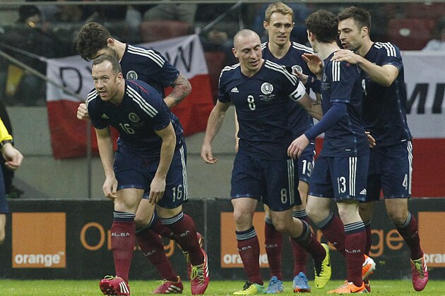 Scotland's players  celebrate after scoring a goal against Poland  during a friendly soccer match between Poland and Scotland in Warsaw, Wednesday March 5, 2014. (AP Photo/Czarek Sokolowski)