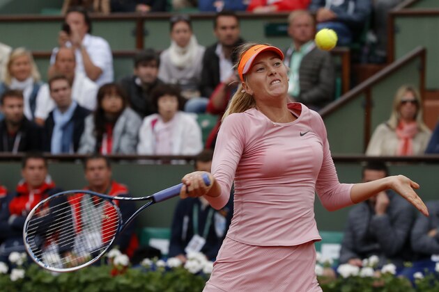 Russia's Maria Sharapova returns the ball to compatriot Ksenia Pervak during their first round match of  the French Open tennis tournament at the Roland Garros stadium, in Paris, France, Monday, May 26, 2014. Sharapova won 6-1, 6-2.  (AP Photo/Michel Euler)