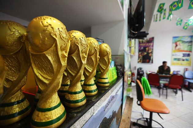 RIO DE JANEIRO, BRAZIL - MAY 19: Replica 2014 FIFA World Cup trophies are displayed in a travel agency which caters to tourists on May 19, 2014 in Rio de Janeiro, Brazil.  Brazil is gearing up to host 600,000 foreign tourists for the 2014 FIFA World Cup which kicks off June 12.  (Photo by Mario Tama/Getty Images)