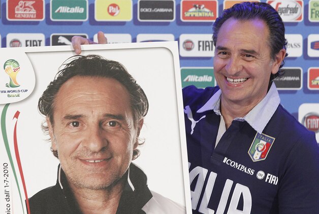 Italy coach Cesare Prandelli  shows a reproduction of his soccer card during a press conference in  Coverciano training complex, in Florence, Italy, Tuesday, May 20 , 2014,   Italy opened its World Cup training camp Monday with 31 players.  Prandelli needs to trim his squad to 23 players by June 2.  In Brazil, Italy is in Group D with England, Uruguay and Costa Rica. (AP Photo/Fabrizio Giovannozzi)