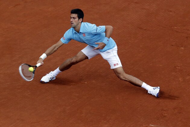 Serbia's Novak Djokovic returns the ball to Portugal's Joao Sousa during their first round match of  the French Open tennis tournament at the Roland Garros stadium, in Paris, France, Monday, May 26, 2014. (AP Photo/Michel Euler)