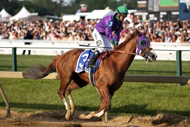 May 17, 2014; Baltimore, MD, USA; Victor Espinoza aboard California Chrome goes around the first turn after winning the 139th Preakness Stakesat Pimlico Race Course. Mandatory Credit: Winslow Townson-USA TODAY Sports