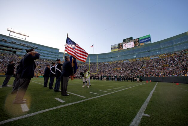 The American flag is presented before a game between the Green Bay Packers and the Buffalo Bills in an NFL exhibition football game Saturday, Aug. 22, 2009, in Green Bay, Wis. (AP Photo/Andy Manis)