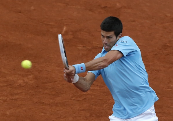 Serbia's Novak Djokovic returns the ball to Portugal's Joao Sousa during their first round match of  the French Open tennis tournament at the Roland Garros stadium, in Paris, France, Monday, May 26, 2014. (AP Photo/Michel Euler)