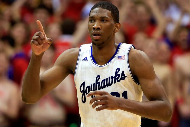 LAWRENCE, KS - JANUARY 18:  Joel Embiid #21 of the Kansas Jayhawks reacts after scoring during the game against the Oklahoma State Cowboys at Allen Fieldhouse on January 18, 2014 in Lawrence, Kansas.  (Photo by Jamie Squire/Getty Images)