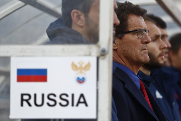 Russia's coach Fabio Capello, second from left, awaits the start of the match before an international friendly soccer match against Armenia in Krasnodar, Russia, Wednesday, March 5, 2014. Russia won 2-0. (AP Photo/Denis Tyrin)