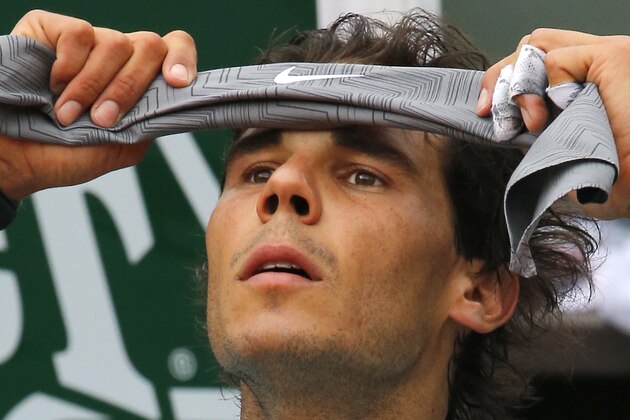 Spain's Rafael Nadal adjusts his head band during a break in the first round match of the French Open tennis tournament against Robby Ginepri of the U.S. at the Roland Garros stadium, in Paris, France, Monday, May 26, 2014. (AP Photo/Michel Spingler)