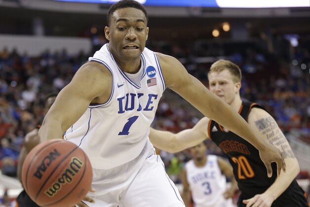 Duke forward Jabari Parker (1) works against Mercer forward Jakob Gollon (20) during the first half of an NCAA college basketball second-round game, Friday, March 21, 2014, in Raleigh, N.C. (AP Photo/Gerry Broome)