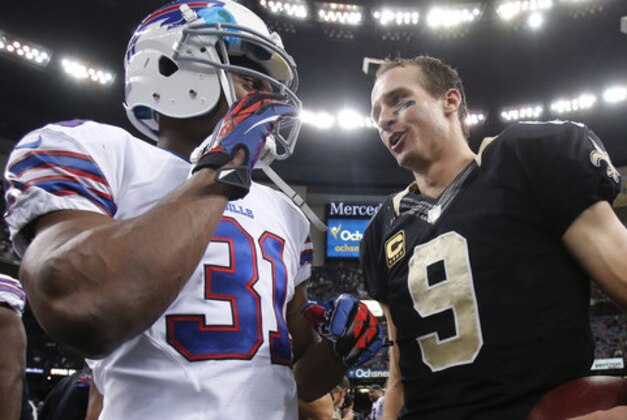 New Orleans Saints quarterback Drew Brees (9) talks with Buffalo Bills free safety Jairus Byrd (31) after an NFL football game in New Orleans, Sunday, Oct. 27, 2013.  The Saints won 35-17. (AP Photo/Bill Haber)