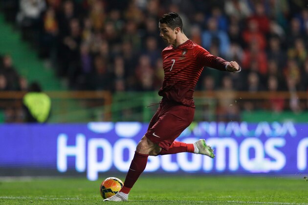 Portugal's Cristiano Ronaldo shoots to score the opening goal during their friendly soccer match with Cameroon Wednesday, March 5 2014, in Leiria, Portugal. It was Ronaldo's 48th goal with Portugal making him the national team's best scorer ever. (AP Photo/Armando Franca)