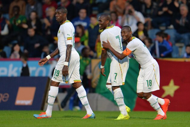Cameroon's Mohammadou Idrissou, from left, Landry N'Guemo and Eyong Enow celebrate after scoring during their friendly soccer match against Macedonia in Kufstein, Austrian province of Tyrol, on Monday, May 26, 2014. (AP Photo/Kerstin Joensson)