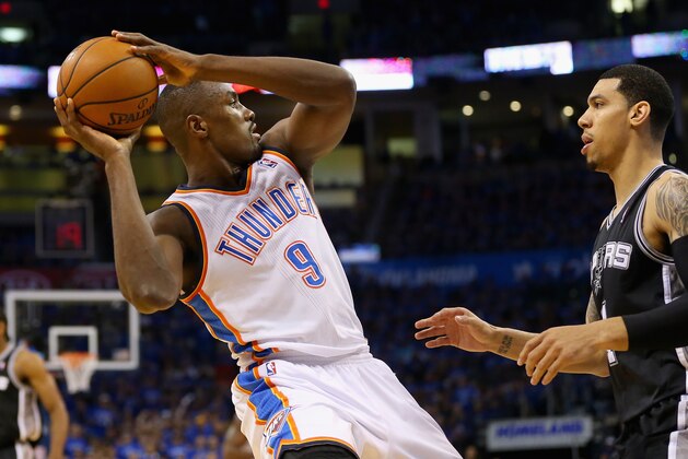 OKLAHOMA CITY, OK - MAY 25: Serge Ibaka #9 of the Oklahoma City Thunder handles the ball against Danny Green #4 of the San Antonio Spurs in the second half during Game Three of the Western Conference Finals of the 2014 NBA Playoffs at Chesapeake Energy Arena on May 25, 2014 in Oklahoma City, Oklahoma.  (Photo by Ronald Martinez/Getty Images)