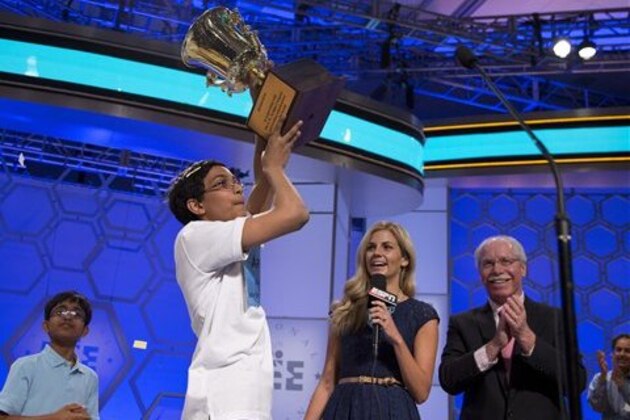Arvind Mahankali, 13, of Bayside Hills, N.Y., lifts the championship trophy after he won the National Spelling Bee by spelling the word