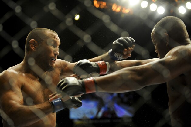 May 24, 2014; Las Vegas, NV, USA; Daniel Cormeir (red) blocks a punch by Dan Henderson (blue) during their UFC 173 light heavyweight bout at MGM Grand Garden Arena. Cormeir won his bout by way of submission. Mandatory Credit: Stephen R. Sylvanie-USA TODAY Sports