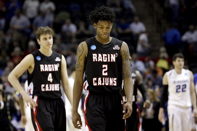 Louisiana Lafayette's Elfrid Payton (2) and Steven Wronkoski (4) walks off the court after losing to Creighton in a second-round game in the NCAA college basketball tournament Friday, March 21, 2014, in San Antonio. Creighton won 76-66.(AP Photo/David J. Phillip)