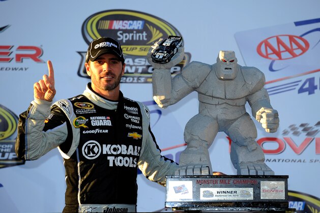 DOVER, DE - SEPTEMBER 29:  Jimmie Johnson, driver of the #48 Lowe's / Kobalt Tools Chevrolet, poses with the 'Miles the Monster' trophy after winning the NASCAR Sprint Cup Series AAA 400 at Dover International Speedway on September 29, 2013 in Dover, Delaware.  (Photo by Jared C. Tilton/Getty Images)