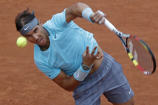 Spain's Rafael Nadal serves the ball during the first round match of the French Open tennis tournament against Robby Ginepri of the U.S. at the Roland Garros stadium, in Paris, France, Monday, May 26, 2014. (AP Photo/Michel Euler)