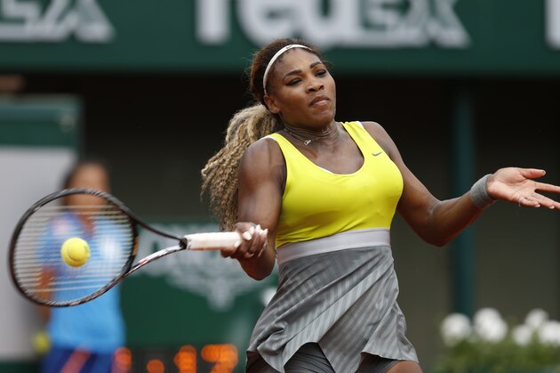 Serena Williams of the U.S, returns the ball to France's Alize Lim during the first round match of  the French Open tennis tournament at the Roland Garros stadium, in Paris, France, Sunday, May 25, 2014. Williams won 6-2, 6-1. (AP Photo/Darko Vojinovic)