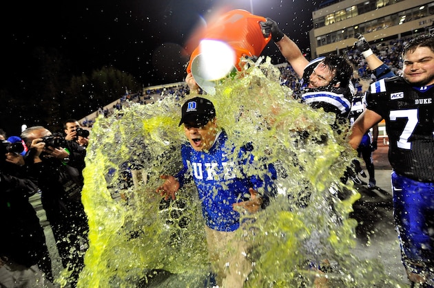 DURHAM, NC - NOVEMBER 16:  Players dump Gatorade on coach David Cutcliffe of the Duke Blue Devils to celebrate a win over the Miami Hurricanes at Wallace Wade Stadium on November 16, 2013 in Durham, North Carolina. Duke won 48-30.  (Photo by Grant Halverson/Getty Images)