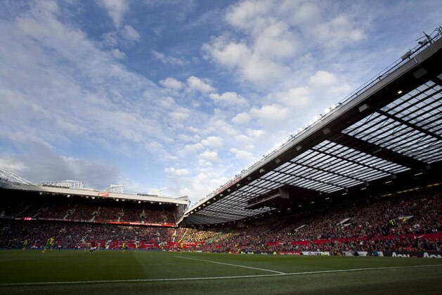 The stands are seen in the evening sunlight as Manchester United win 4-0 against Norwich City in their English Premier League soccer match at Old Trafford Stadium, Manchester, England, Saturday April 26, 2014. (AP Photo/Jon Super)