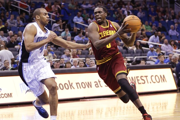 Cleveland Cavaliers' Luol Deng, right, drives around Orlando Magic's Arron Afflalo, left, during the first half of an NBA basketball game in Orlando, Fla., Wednesday, April 2, 2014. (AP Photo/John Raoux)