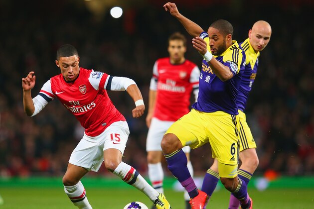 LONDON, ENGLAND - MARCH 25:  Alex Oxlade-Chamberlain of Arsenal and Ashley Williams of Swansea City battle for the ball during the Barclays Premier League match between Arsenal and Swansea City at Emirates Stadium on March 25, 2014 in London, England.  (Photo by Julian Finney/Getty Images)