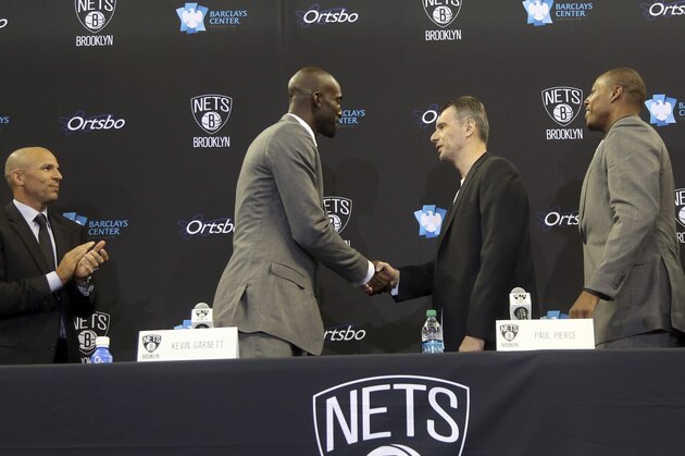 Brooklyn Nets head coach Jason Kidd, left, Kevin Garnett, second from left, Paul Pierce, second from right, and Jason Terry, right greet team owner Mikhail Prokhorov, center, as he arrives at an NBA basketball news conference, Thursday, July 18, 2013, at Barlcays Center in New York. The Nets introduced their newest players, Garnett, Pierce and Terry, whom they acquired in a trade with the Boston Celtics. (AP Photo/Mary Altaffer)