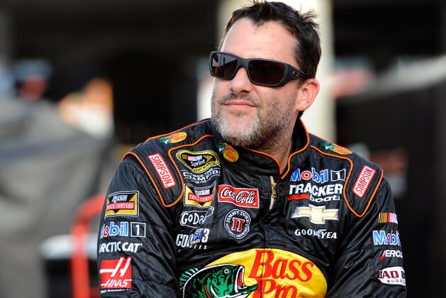 CHARLOTTE, NC - MAY 22: Tony Stewart, driver of the #14 Bass Pro Shops/Mobil 1 Chevrolet, sits on the pit wall during qualifying for the NASCAR Sprint Cup Series Coca-Cola 600 at Charlotte Motor Speedway on May 22, 2014 in Charlotte, North Carolina.  (Photo by Jared C. Tilton/Getty Images)