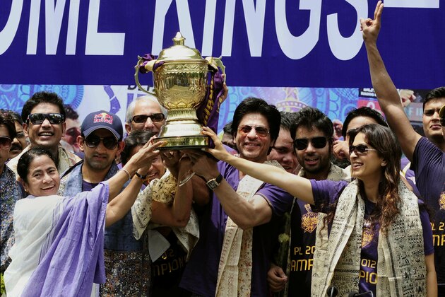Kolkata Knight Riders team co-owners and Bollywood actors Shah Rukh Khan, center and Juhi Chawla, second right, pose with West Bengal state Chief Minister Mamata Banerjee, left, and captain Gautam Gambhir, second left in cap, during a reception accorded to the team at the Eden Gardens stadium in Kolkata, India, Tuesday, May 29, 2012. Kolkata Knight Riders won the Indian Premier League cricket title on Sunday, defeating two-time defending champion Chennai Super Kings by five wickets in a high-scoring final. (AP Photo)
