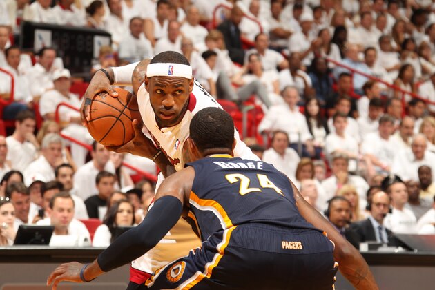 MIAMI, FL - May 26: LeBron James #6 of the Miami Heat controls the ball against Paul George #24 of the Indiana Pacers in Game Four of the Eastern Conference Finals during the 2014 NBA Playoffs at the American Airlines Arena in Miami, Florida on May 26, 2014. NOTE TO USER: User expressly acknowledges and agrees that, by downloading and/or using this photograph, user is consenting to the terms and conditions of the Getty Images License Agreement. Mandatory copyright notice: Copyright NBAE 2014 (Photo by Issac Baldizon/NBAE via Getty Images)